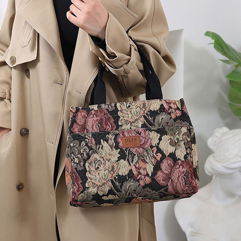 This retro handbag features a tote flower oil painting style. It's convenient to carry a lunch box to work. It has a large capacity and is a mommy bag for going out full figure