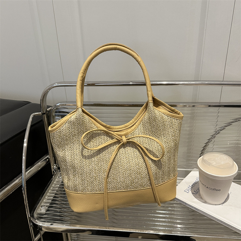 Verano 2025 bowknot axila bolso femenino moda casual bolso de mano de gran capacidad bolso de hombro de color de contraste de paja de nicho