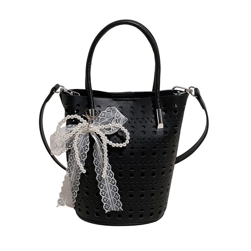 Bolso de cubo de diseño de nicho 2025 nuevo bolso de hombro con agujero hueco bolso de mensajero con lazo de estilo occidental mujer