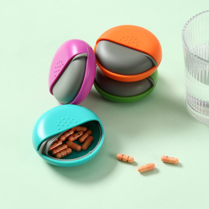 Los fabricantes suministran caja de medicina redonda de una rejilla caja de almacenamiento de plástico Push-Pull caja de medicina caja de embalaje portátil al por mayor