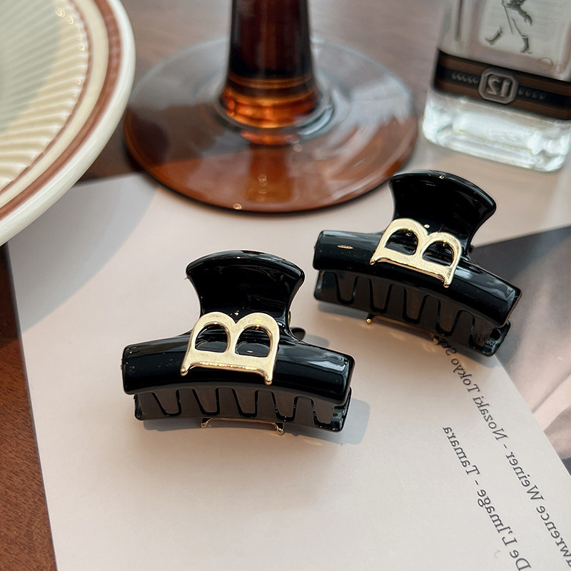 Elegant black crab pin with letters