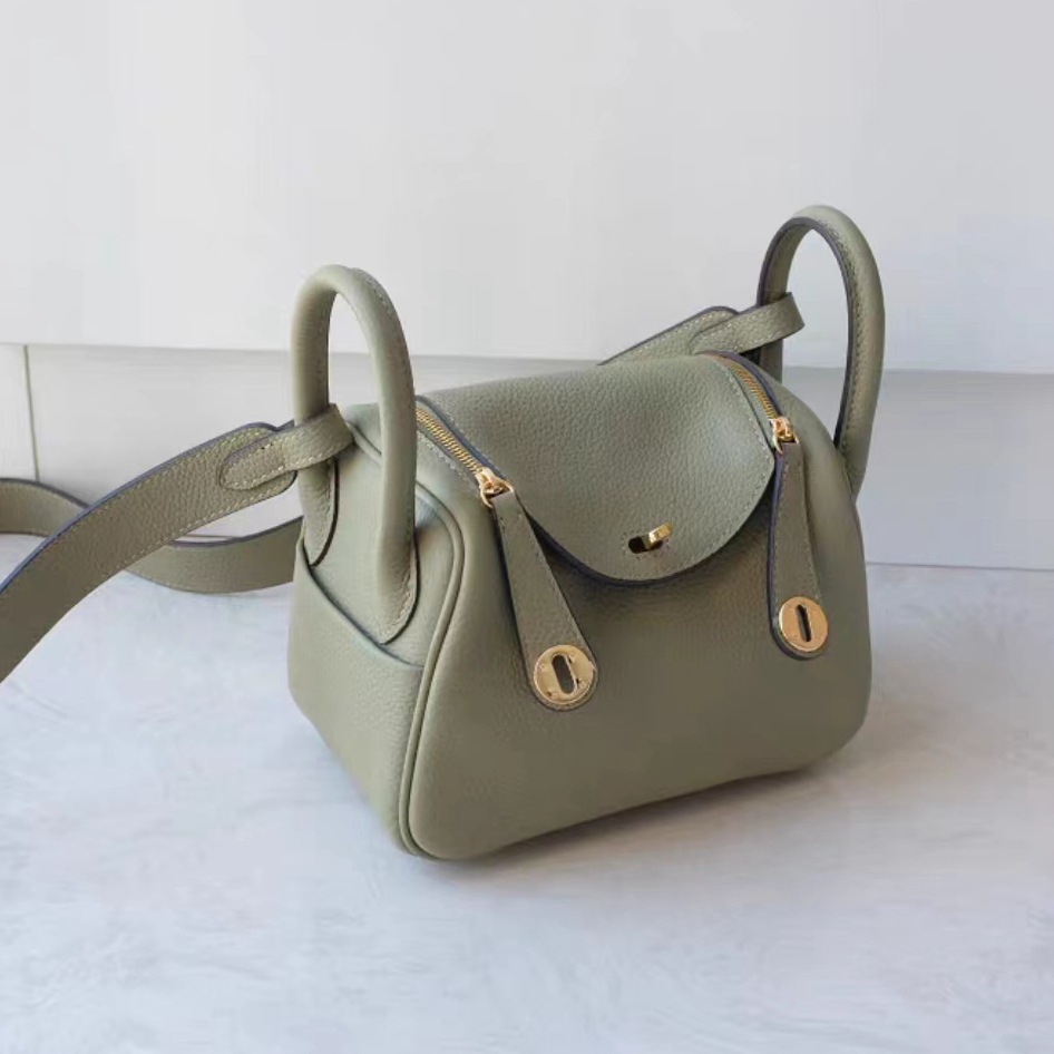 Bolsos de cuero Lindy de piel de vaca con togo de primera capa 2025 Bolsos de cubo retro de estilo europeo y americano Bolsos portátiles de moda