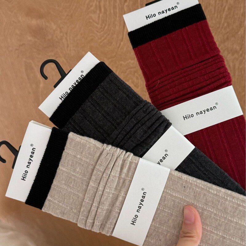 Mid-calf socks, retro, low-cut, relaxed, saturated color, seamless, ribbed, and with a ruffled hem, embodying a "old money" aesthetic for women