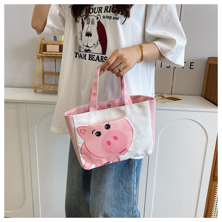 Cute cartoon printed small bag, 2024 summer new style hand-held piggy girl handbag, student storage canvas bag undefined