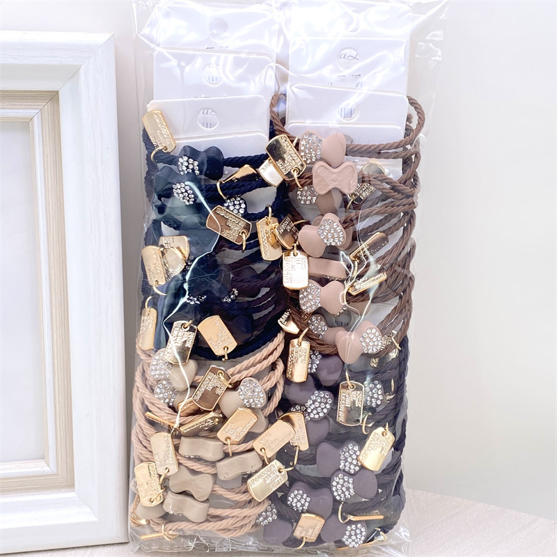 Etiqueta de estilo coreano accesorios para el cabello para niños Perla pequeña pajarita cuerda de pelo chica estudiante cabeza cuerda banda de goma dos yuanes suministro de la tienda