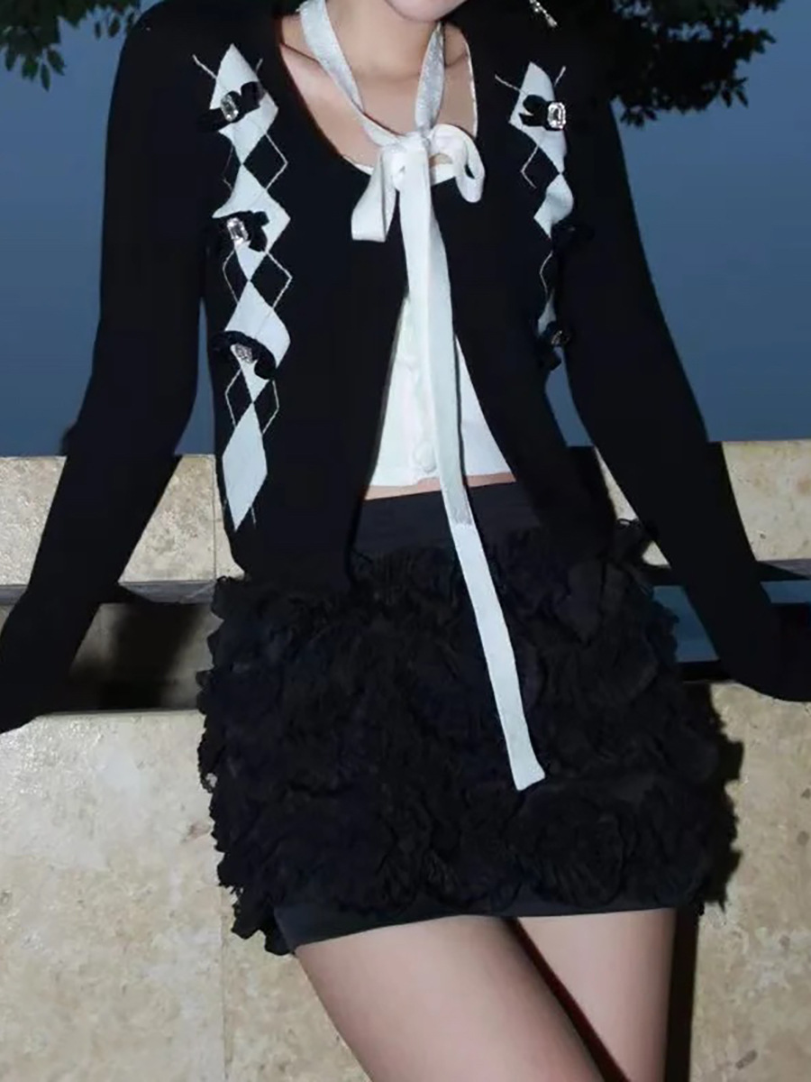 2025年の春の新商品のモダンな白黒の衝突色のリボンは菱格のニットの上着の秋のファッションの高級感をつなぎ合わせます。