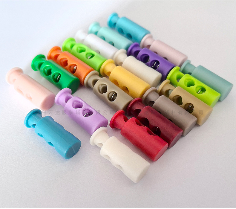 Kunststoff-Farbfedern-Schnallenverschluss, zweilöchrige zylindrische Seilschnalle, Daunenjacken-Verstellschnalle, Elastic-Stopper, Rutschfester Verschluss, Glockenform-Schnalle
