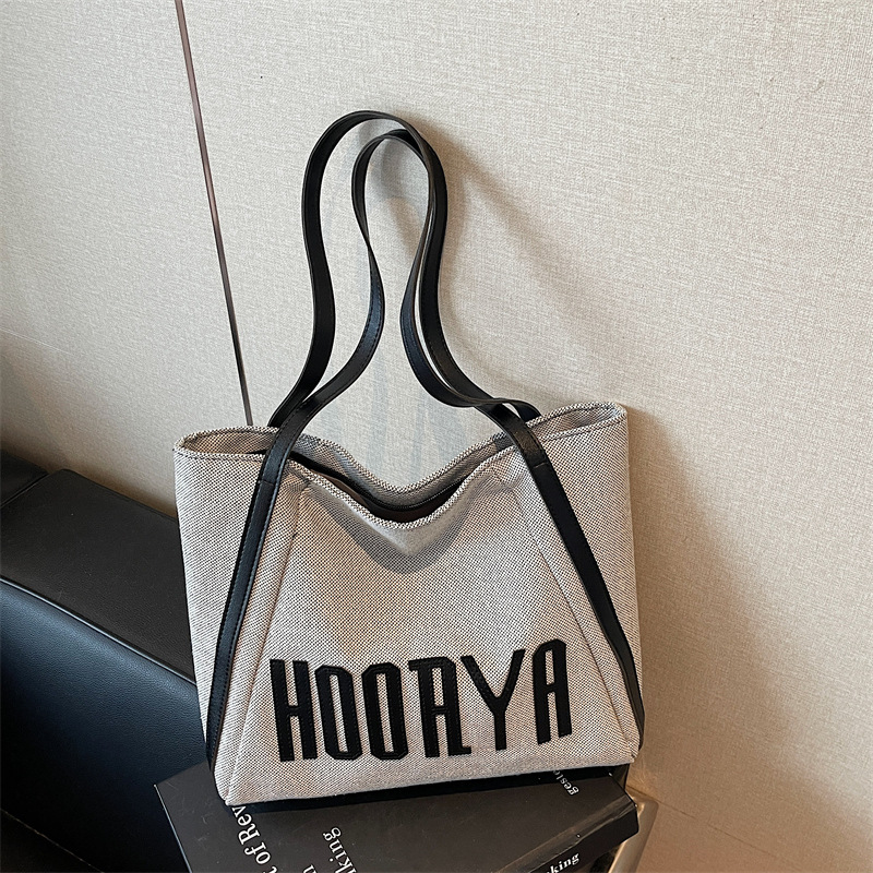 Bolsa de lona de gran capacidad para viajes 2025 nueva bolsa de mujer bolsa de hombro casual estilo exterior versátil bolso universitario