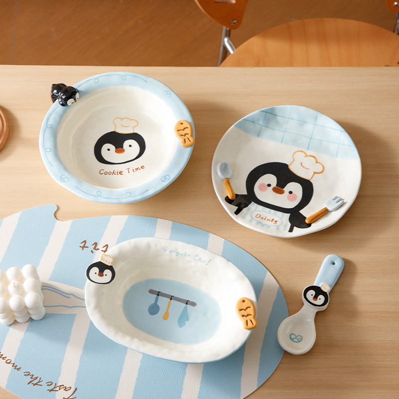 Cute and fresh penguin-shaped tableware set made of ceramic material for home use, including bowl, plate, and cup for one person Cute and fresh penguin-shaped tableware set made of ceramic material for home use, including bowl, plate, and cup for one person