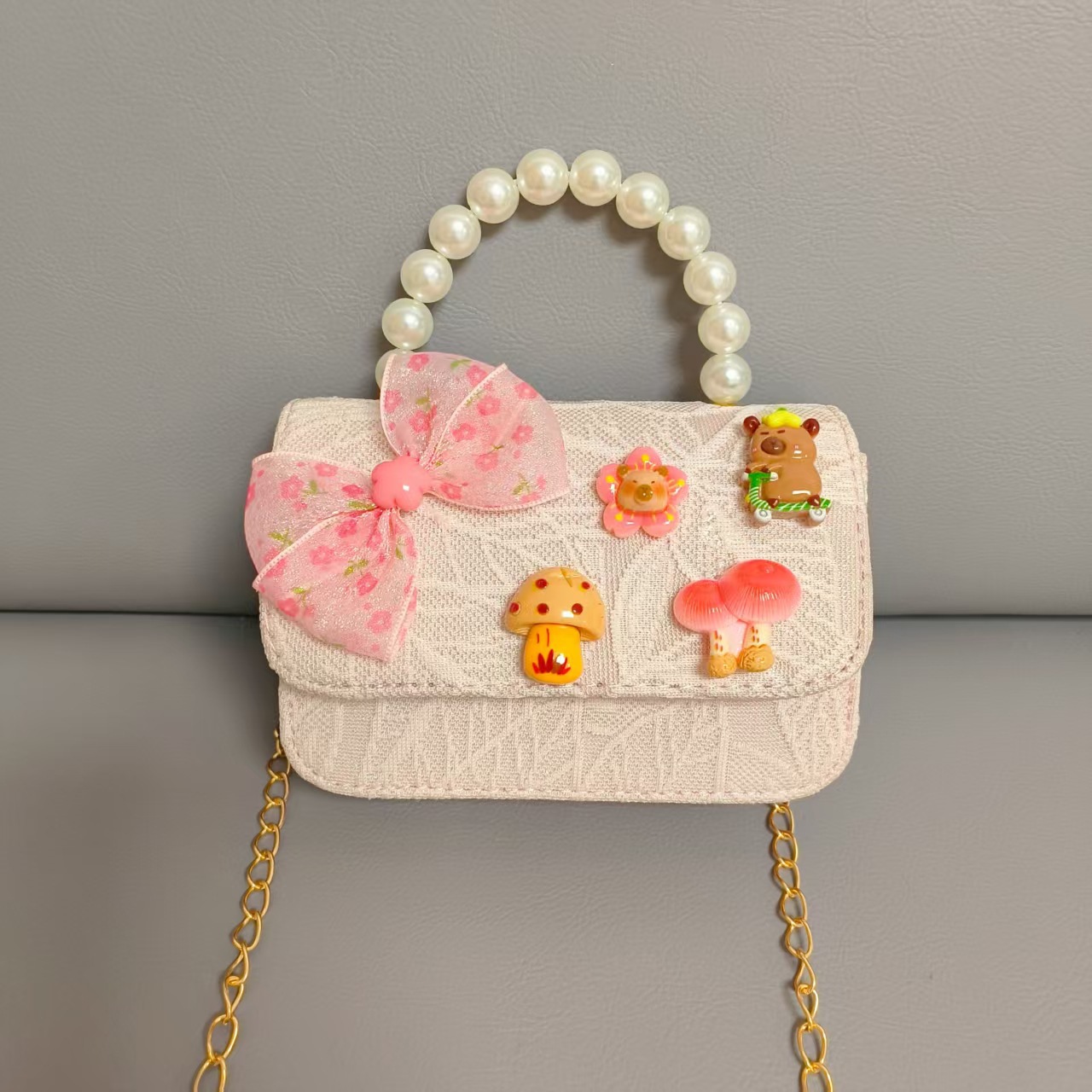 Bolsos para niños nuevos bolsos de perlas de arco para niñas bolsos de cinturón de estilo de fragancia bolsos de cadena bolsos de cambio bolsos