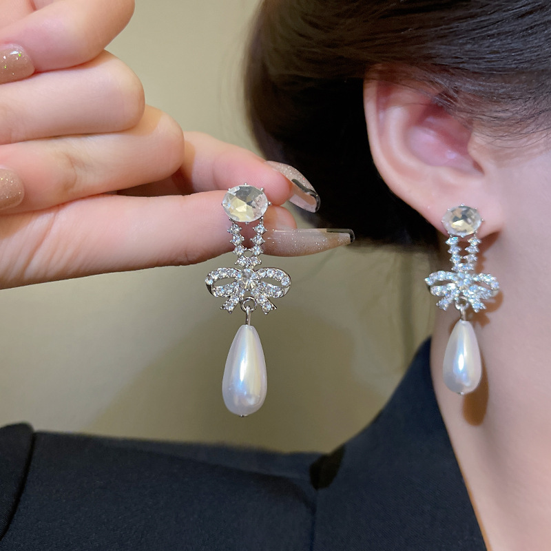 Small design sophisticated universal earrings with bow from pearl