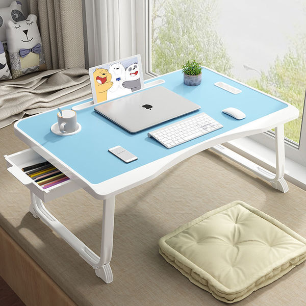 Folding the mobile lifting laptop computer table beside bed