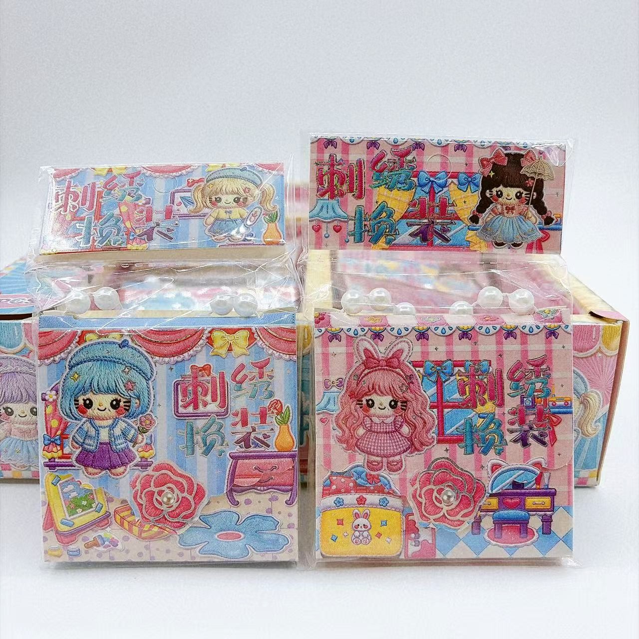 Children's toy embroidery dress-up kit with hand-held packaging, featuring cute girl toys, DIY craft stickers, and a sticker book for creating scenes