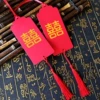 30 hot stamping 囍 characters with 10 meters of red ribbon + red tassels