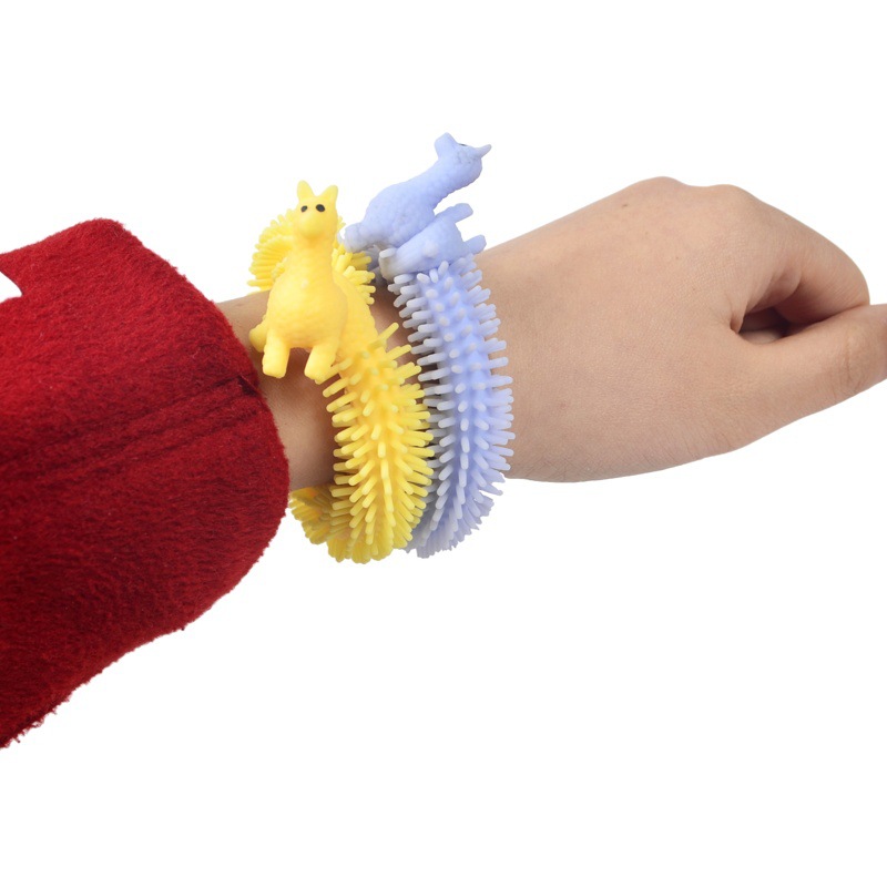 Amazon Venta caliente creativo nuevo dinosaurio Lala descompresión ventilación cuerda dibujos animados alpaca pulsera pull fideos