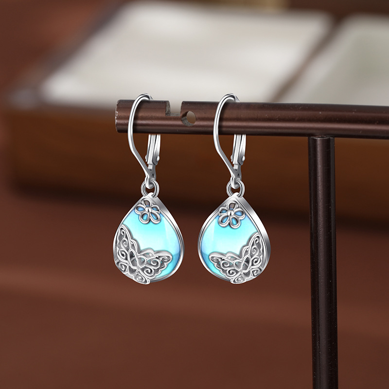 925 aretes de mariposa de flores de plata esterlina para mujeres lujosas europeas y estadounidenses de alta sensación de auriculares de piedra de luz de la luna Amazon auriculares transfronterizos