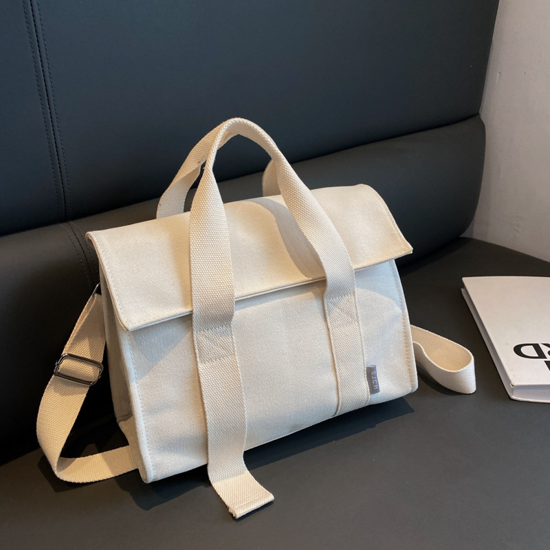 Comercio exterior bolsa de lona para las mujeres 2023 nueva moda japonesa y coreana bolsa de mano portátil nicho de alta calidad bolsa de mensajero del hombro
