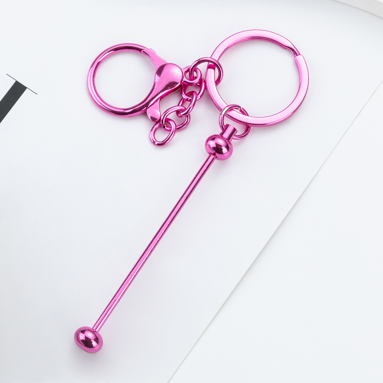 DIY cuentas llaveros auriculares caja de teléfono celular colgante llaveros de metal chapeado UV llaveros al por mayor spot