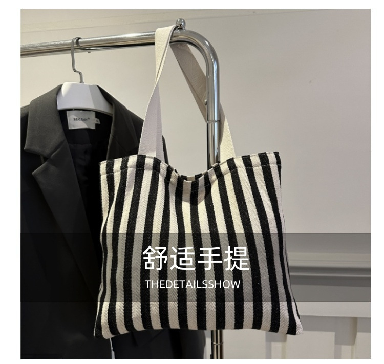 The new cross-border vertical striped commuter tote bag, hand-held shoulder bag, is fashionable and has a large capacity. It features an InS-style simple letter sail undefined