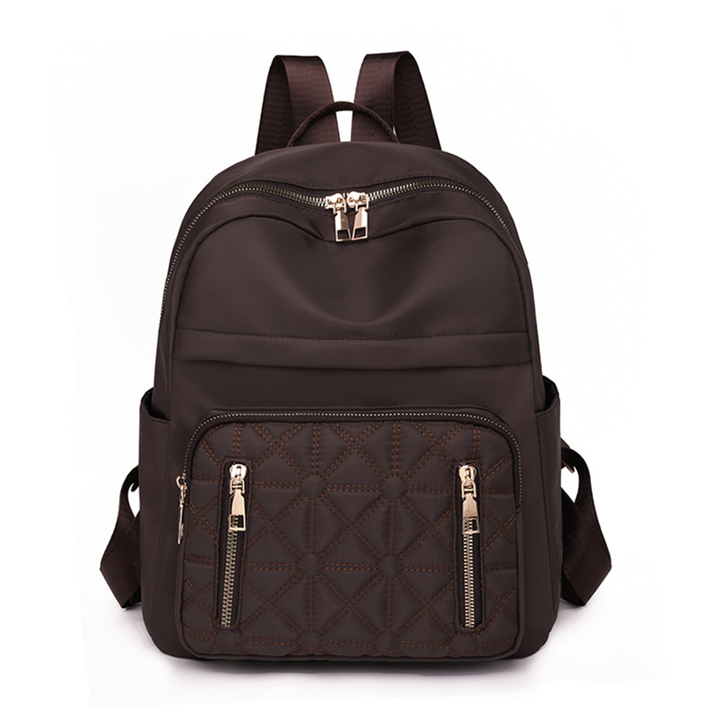 Comercio exterior al por mayor 2023 nueva versión coreana de la mochila de nailon para mujer, línea de bordado de moda, mochila de viaje al aire libre de todo fósforo, marea