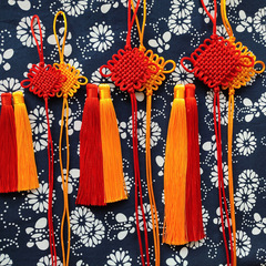 Craft your own DIY car accessory with handmade bindings, red ropes, woven threads, tassels, and self-tied Five Emperors' coins.