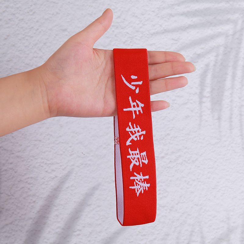 Boy with white letters on red background, I am the best