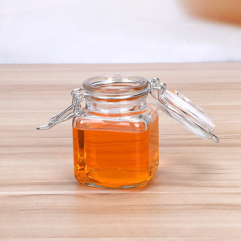 Amazon pequeña hebilla 60ml botella de vidrio pequeña botella de vino botella de bebida enzimática aceite comestible aceite de Camelia sub-botella al por mayor