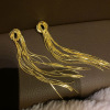 Design advanced long golden earrings, trend of season, light luxury style