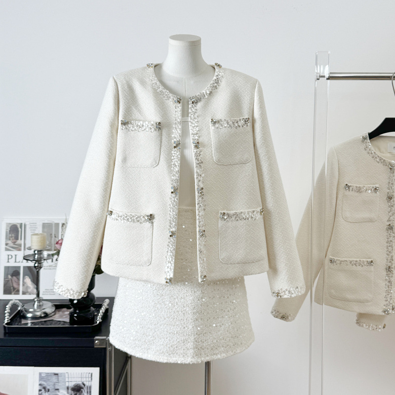 Real shot of a high-end, sophisticated, diamond-embellished white stylish jacket for women, featuring a Chanel-inspired design and made of high-quality tweed with beaded detailing
