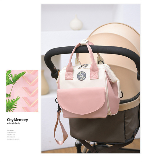 The Mommy bag is small and cute. It has a detachable front pocket and is a multi-functional baby bag. It is waterproof, lightweight, and has a crossbody design. It can be used to carry milk bags undefined