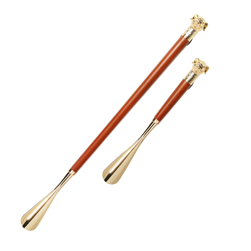 Fábrica en stock Zodiaco cabeza de cerdo de metal zapato extractor conveniente zapato dispositivo de elevación bomba de zapatos