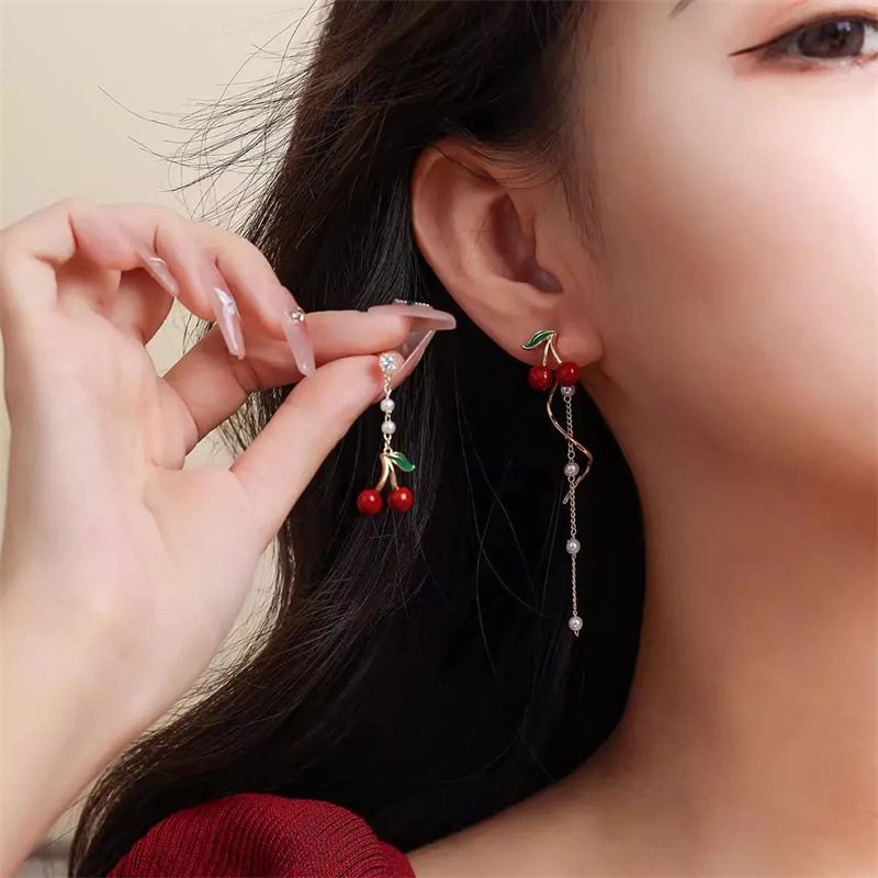 Red asymmetrical design long demi-season earrings with tassels