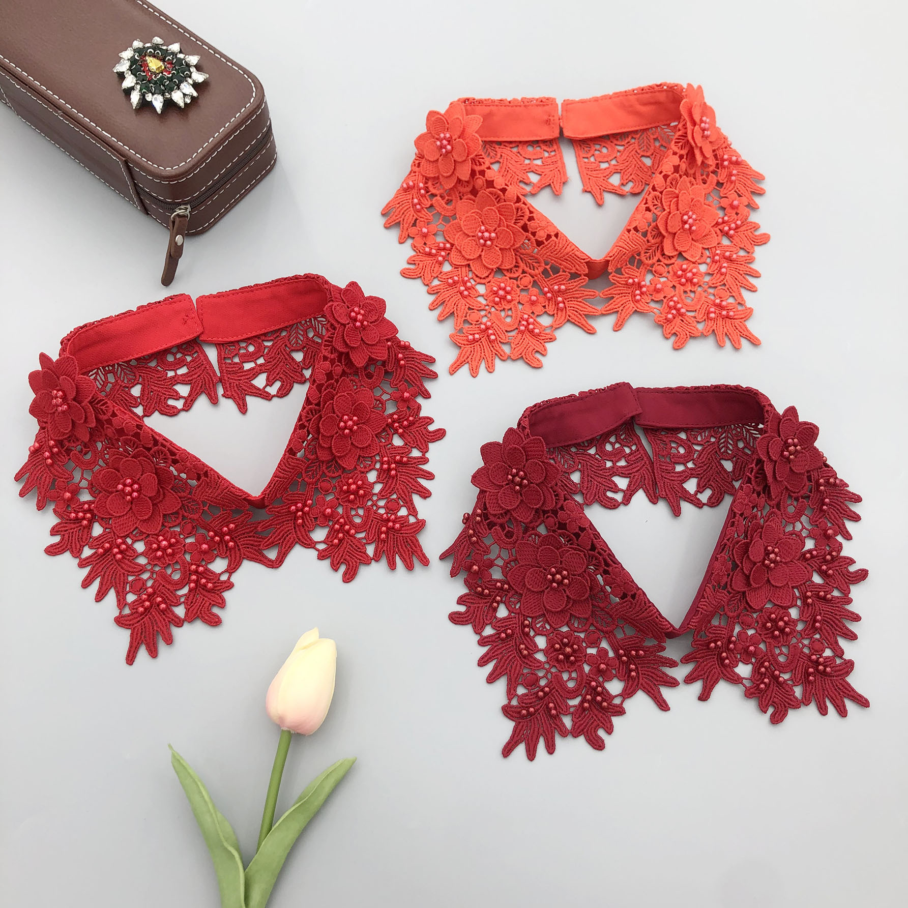 Our factory produces sand-soluble embroidered faux collars with three-dimensional floral accents—plus a wide range of other faux collar accessories!