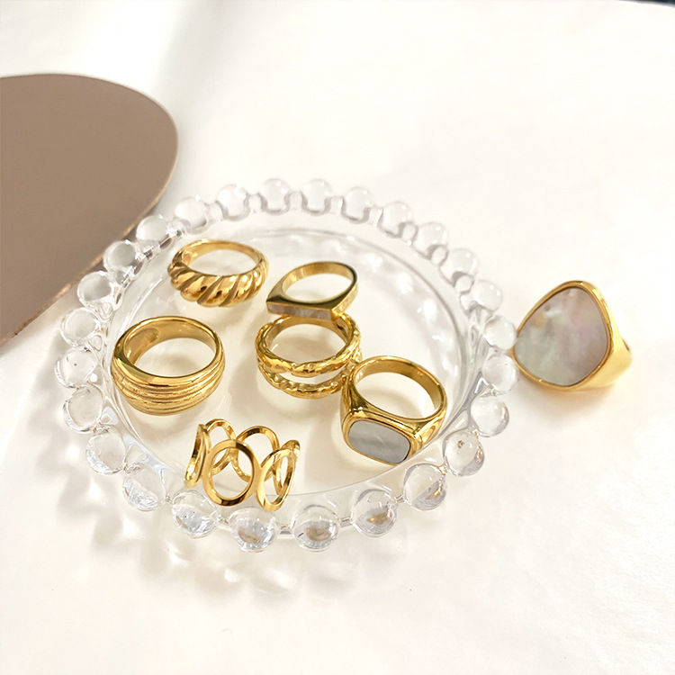 Titanium-steel in-furnace gold-plated ring with shell design, closed-end style—matching the trendy European and American Instagram-inspired, uniquely crafted twisted geometric ring for women.