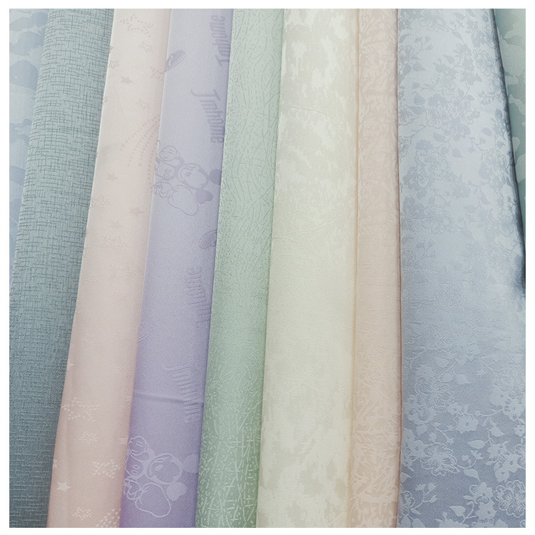 现货供应涤纶哑光提花小碎点芝麻点弹力提花布女装童装汉服面料