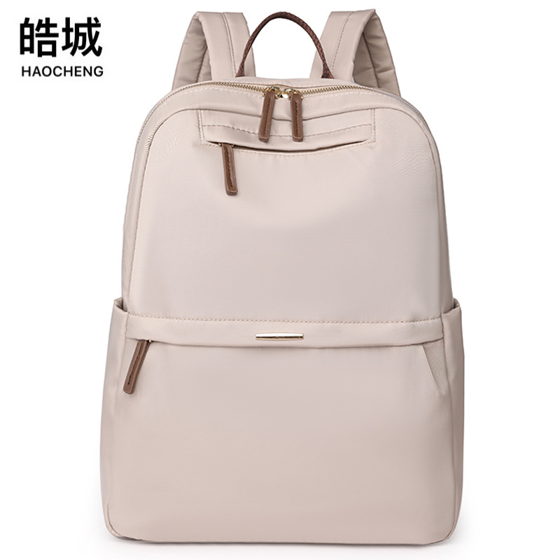 En stock al por mayor 2024 nuevas mujeres mochila de nylon simple color sólido gran capacidad ordenador mochila estudiante
