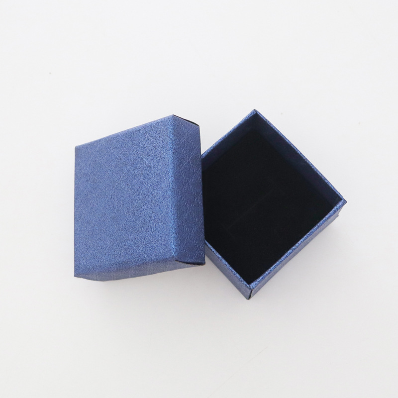 Nueva caja de papel pequeña de margarita, joyería de franela de alta gama, joyería, anillo, pendientes, caja de embalaje universal al por mayor