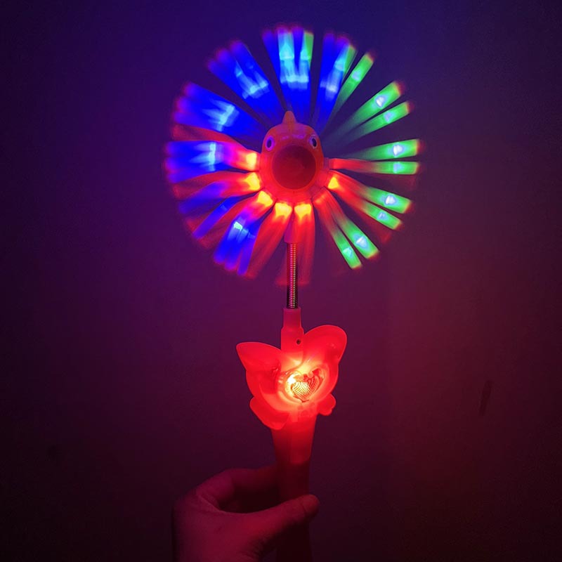 Molino de viento de cabeza de pescado luminoso giratorio de mano para niños palo de luz nocturna palo de flash de música molino de viento de pescado barraca de juguetes para niños lote