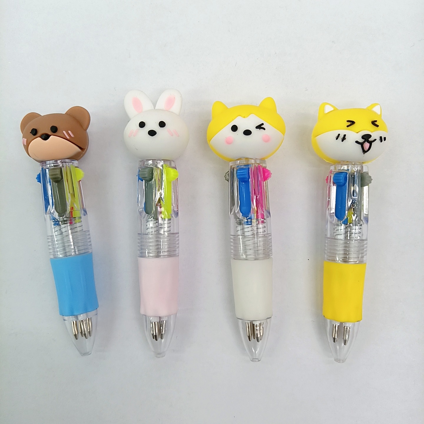 Fabricante mayorista de cuatro colores bolígrafo de silicona bolígrafo multicolor de dibujos animados cabeza portátil de estudiantes