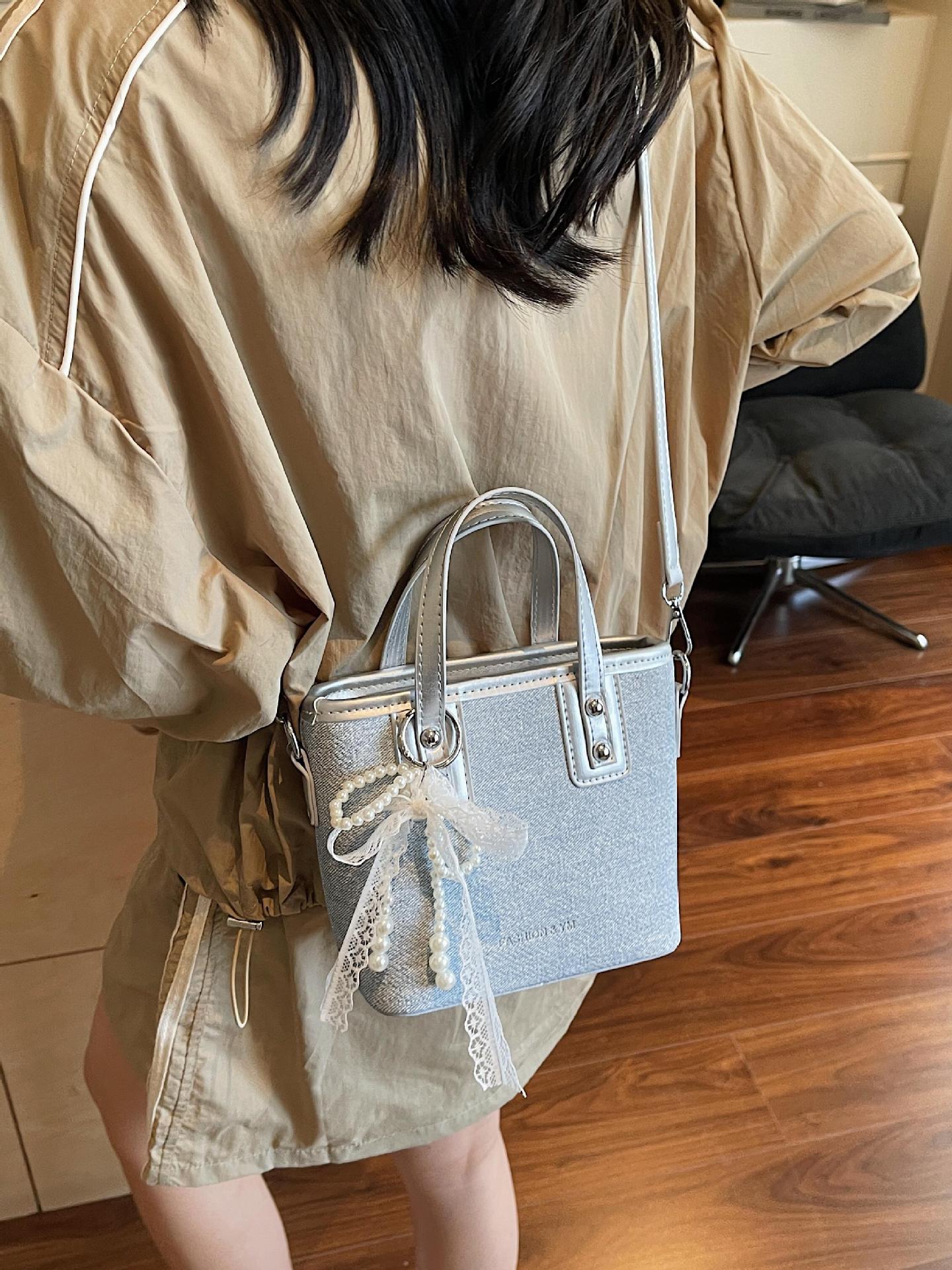 Bolso de cubo de mano de estilo occidental de moda para mujer 2025 nuevo bolso de hombro de todo fósforo de color de contraste bolso de mensajero de viaje de textura de moda