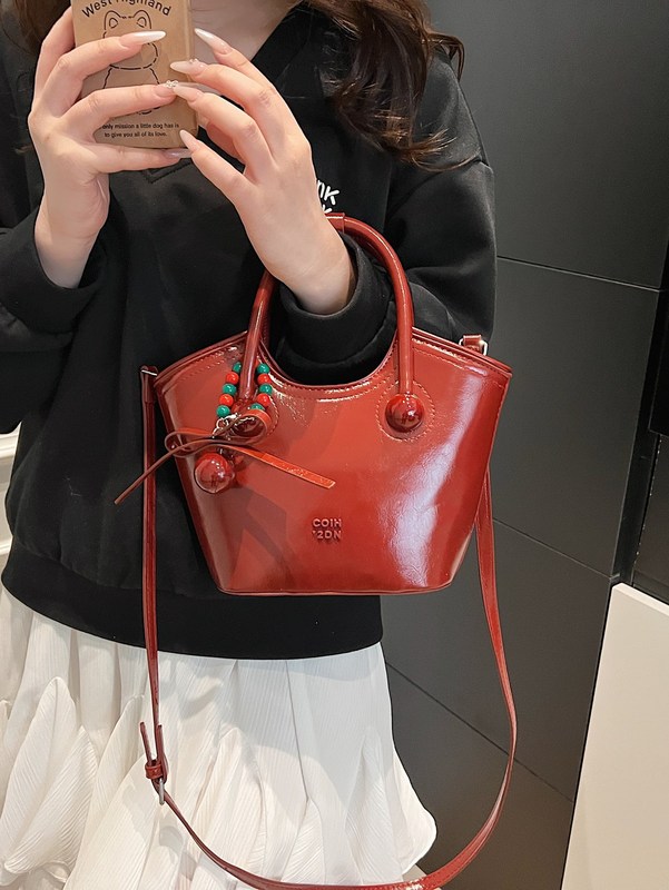 高級感のある結婚カバンと娘のお土産の結婚カバンと女性の花嫁は2025年に新型の赤い斜め掛けの手提げバケツのカバンを持っています。|undefined