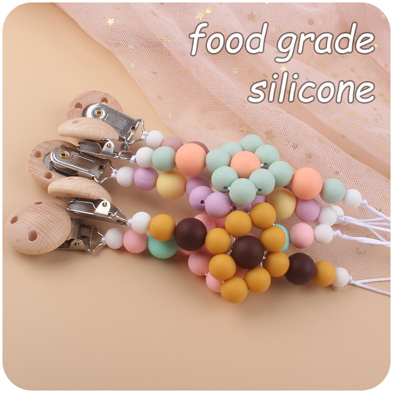 Nuevo bebé suministros calmante clip de chupete de haya creativo bebé mordedura de silicona Cadena de chupete molar cadena anti-gota