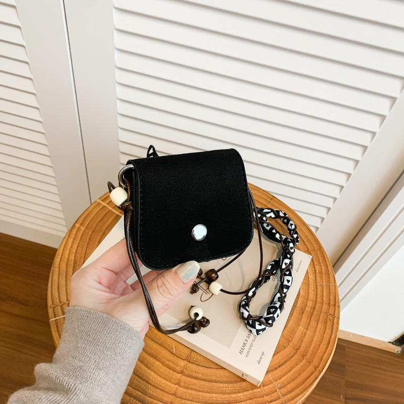 Cross-border premium suede mini saddle bag, new style, scarf-decorated crossbody headphone bag, niche neckband lipstick bag.