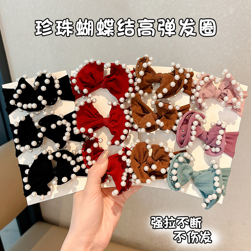 Arco de perla máscara anillo de cabello femenina baja cuerda de cabello bola adornamiento de cabello correa de cuero cuerda de cabello al por mayor