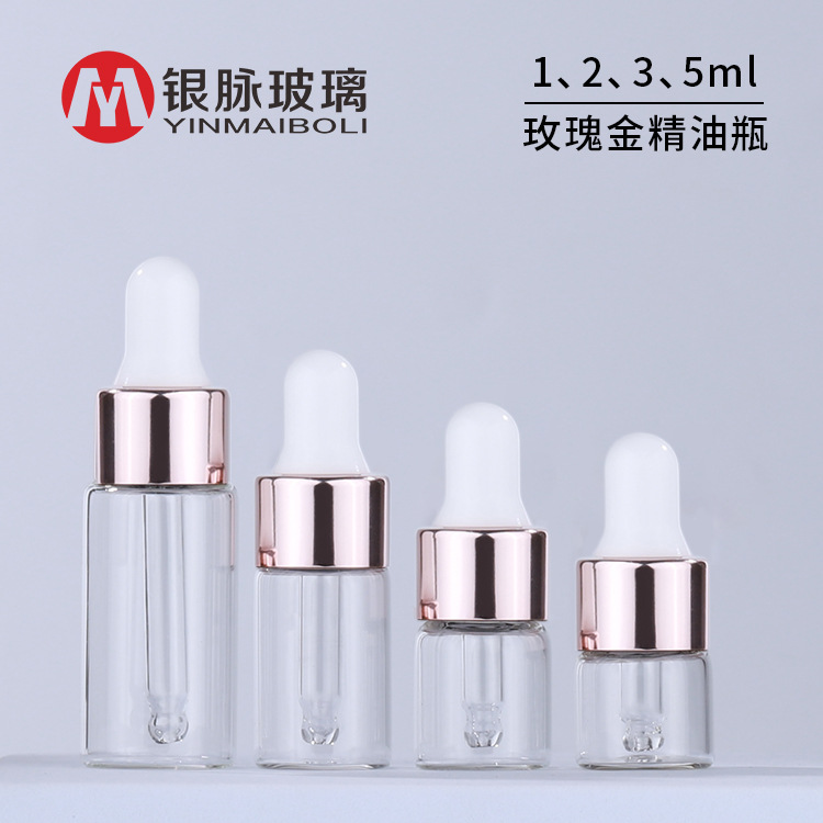 Transparent golden bottle for essential oils contains rose