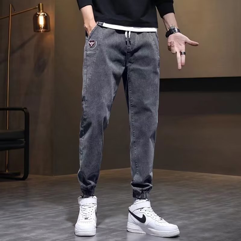 Otoño marca de moda Harlan jeans pantalones de pies pequeños de estilo coreano para hombres pantalones elásticos sueltos de otoño e invierno con cintura elástica para hombres