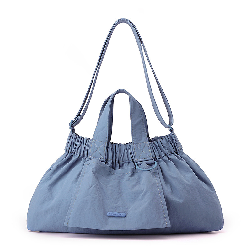 El nuevo diseño de nicho coreano del comercio exterior tiene un sentido del conocimiento de embarque a mano y una bolsa de mujer en el hombro es ligera, casual y plegable.