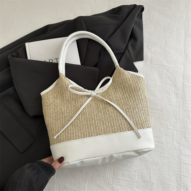 Verano 2025 bowknot axila bolso femenino moda casual bolso de mano de gran capacidad bolso de hombro de color de contraste de paja de nicho