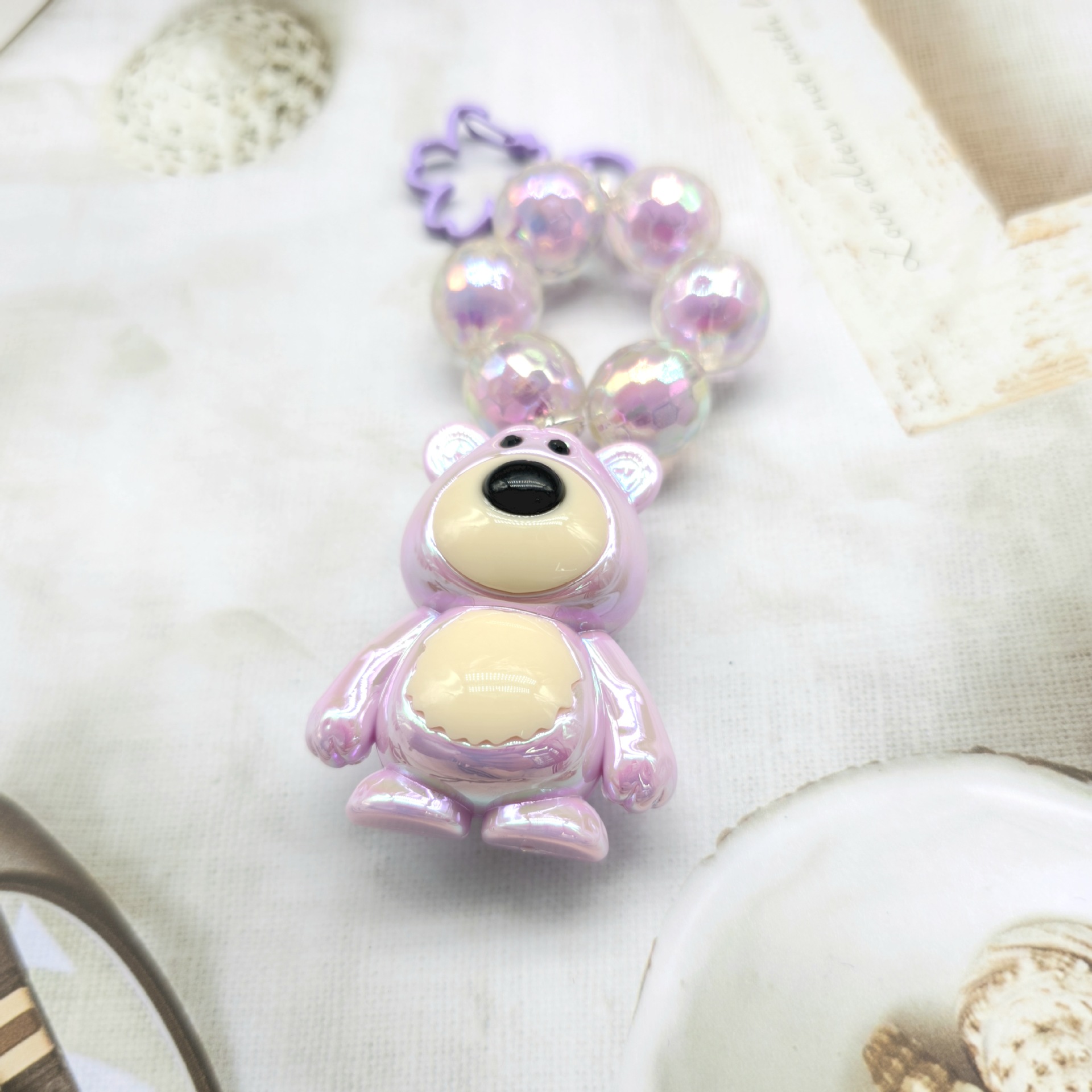 2023 nuevo llavero de cadena de cuentas redondas colgante de oso Cadena de teléfono móvil colorido fresco perla accesorios de color sólido auricular