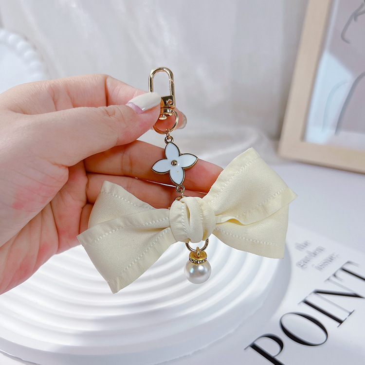 Estilo coreano arrugas cinta arco llavero colgante perla amor chica simple bolsa colgante teléfono móvil colgante